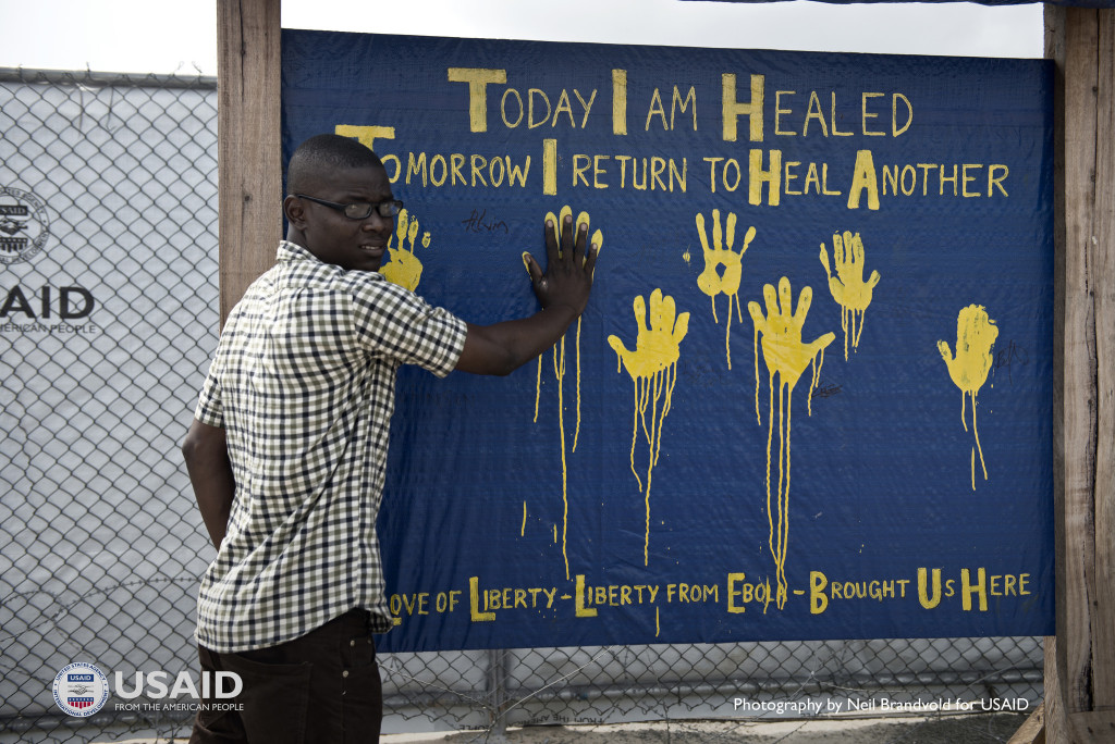 Alivin Davi is an Ebola survivor. He now works at the Monrovia Medical Unit, working to help track down contacts of health care workers who may have contracted Ebola, and giving much-needed psychosocial support to patients undergoing treatment. Photo by Neil Brandvold, USAID