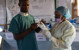 Ebola health care workers donning Personal Protective Equipment