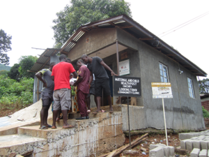Peter Koroma discussing with the team completing the makeover of Looking Town Maternal and Child Health Post, Western Area-Urban, Sierra Leone
